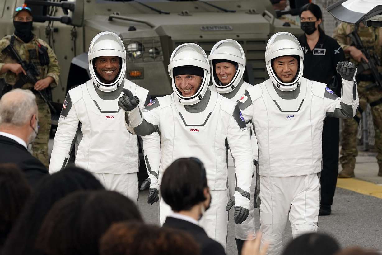 Astronauts, from left, Victor Glover, Michael Hopkins, Shannon Walker, and Japan Aerospace Exploration Agency astronaut Soichi Noguchi wave to family members as they leave the Operations and Checkout Building for a trip to Launch Pad 39-A and planned liftoff on a SpaceX Falcon 9 rocket with the Crew Dragon capsule on a six-month mission to the International Space Station Sunday, Nov. 15, 2020, at the Kennedy Space Center in Cape Canaveral, Fla.