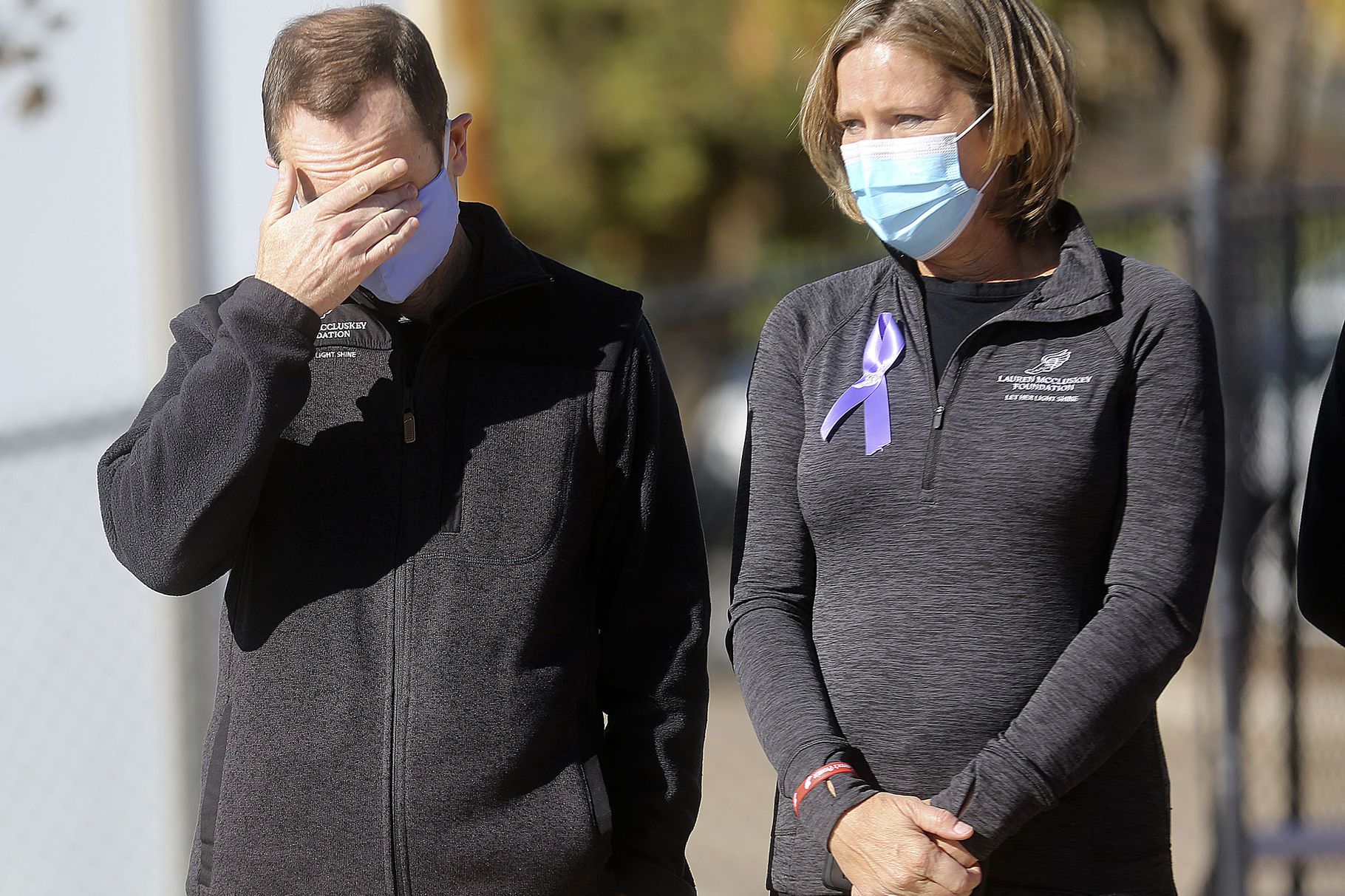 Matt McCluskey, left, wipes his eyes as he and his wife, Jill, listen to a speaker on the two-year anniversary of their daughter Lauren McCluskey’s death at the McCarthey Family Track and Field Complex in Salt Lake City on Thursday, Oct. 22, 2020. Lauren McCluskey, a track athlete, was was shot and killed on campus near her dorm by Melvin Shawn Rowland, 37, after weeks of being stalked and harassed by Rowland.