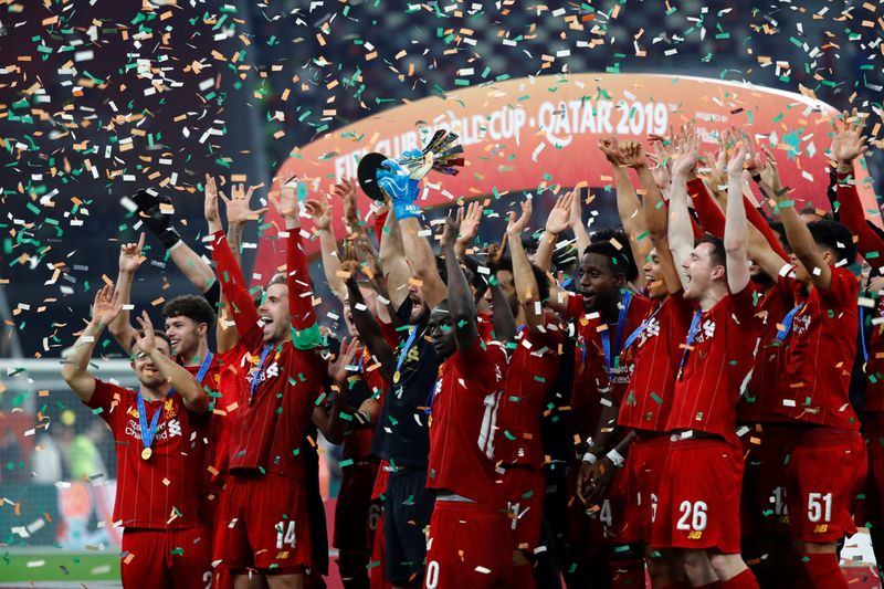 FILE PHOTO: Soccer Football - Club World Cup - Final - Liverpool v Flamengo - Khalifa International Stadium, Doha, Qatar - December 21, 2019  Liverpool's Sadio Mane and teammates celebrate winning the Club World Cup with the trophy. REUTERS/Corinna Kern