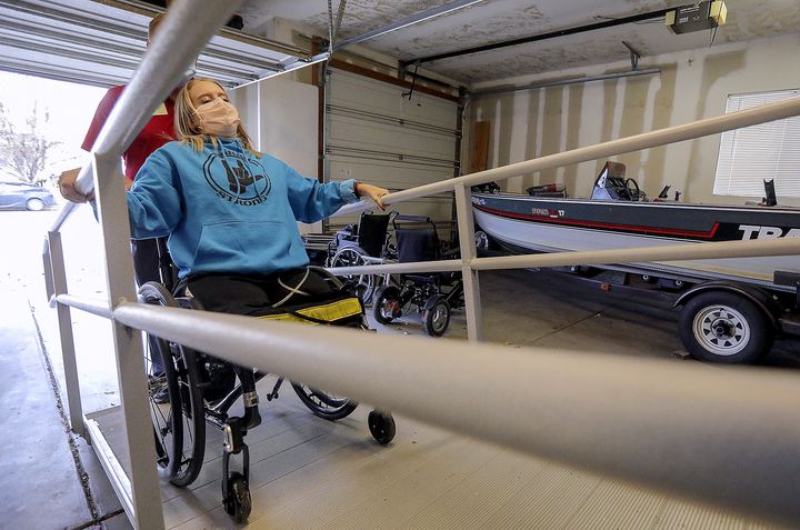 Sarah Frei pulls herself up a ramp into her family’s home in Syracuse on Tuesday, Nov. 17, 2020.