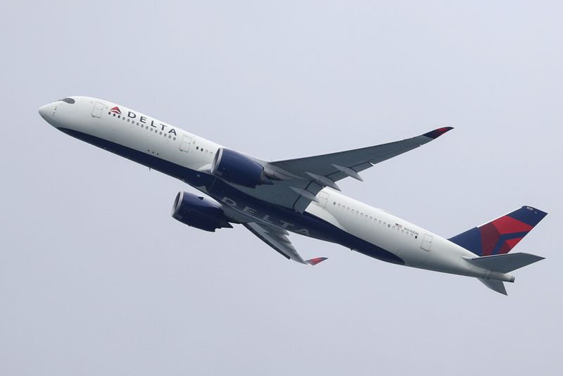 FILE PHOTO: A Delta Air Lines Airbus A350-900 plane takes off from Sydney Airport in Sydney, Australia, October 28, 2020.  REUTERS/Loren Elliott