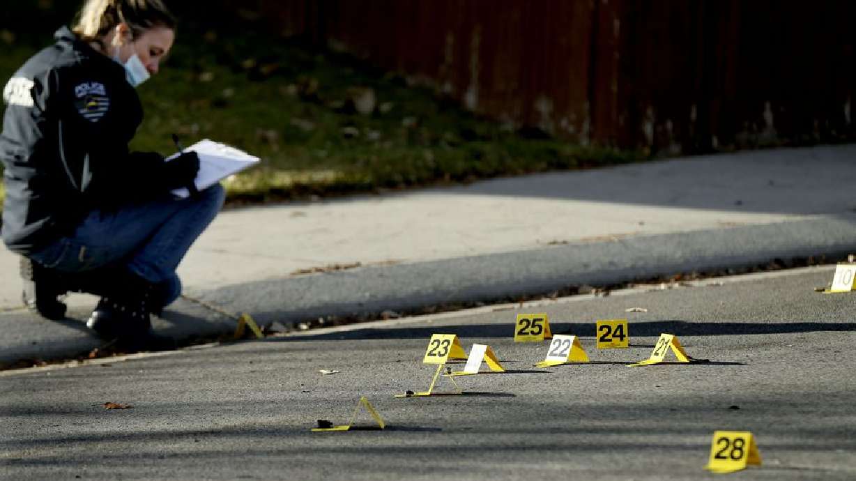 A West Jordan police officer investigates the scene of a shooting that left one man dead in West Jordan on Thursday, Nov. 19, 2020. Officers responded to the area of 7000 South and 5200 West about 2:30 a.m. and found a man deceased in the street.