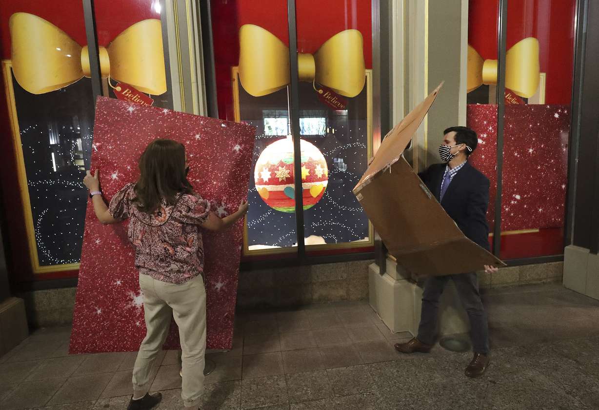 Artist Holly Jones, left, and Make-A-Wish's Daniel Dudley unveil Jones' creations in the holiday candy window displays at Macy's City Creek Center in Salt Lake City on Thursday, Nov. 19, 2020.