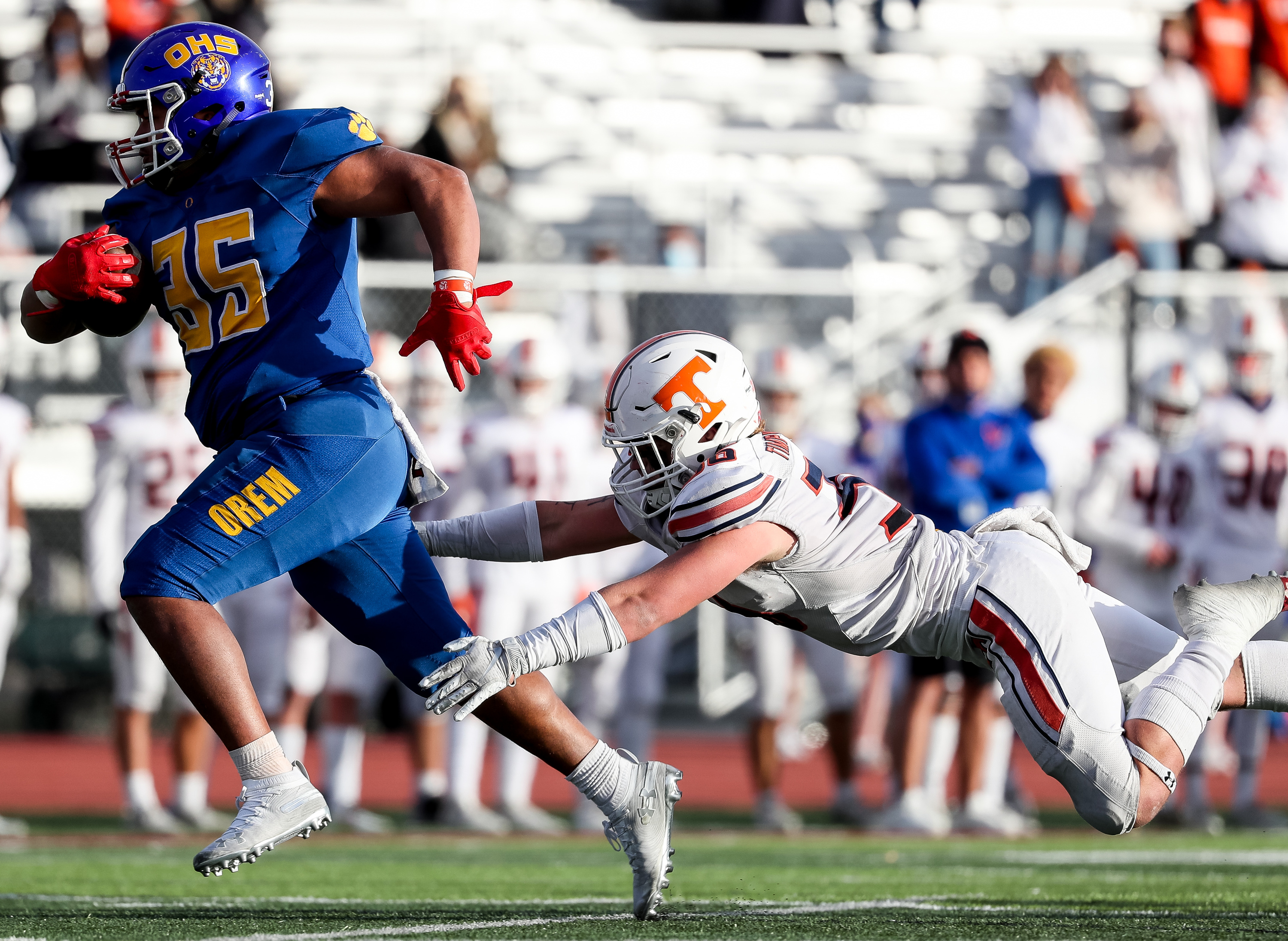 Orem's Paxton Skipps evades a tackle from Timpview's Cael Richardson as Skipps runs the ball for a touchdown, making the score tied at 6, in the 5A football state championship game at Cedar Valley High in Eagle Mountain on Friday, Nov. 20, 2020.