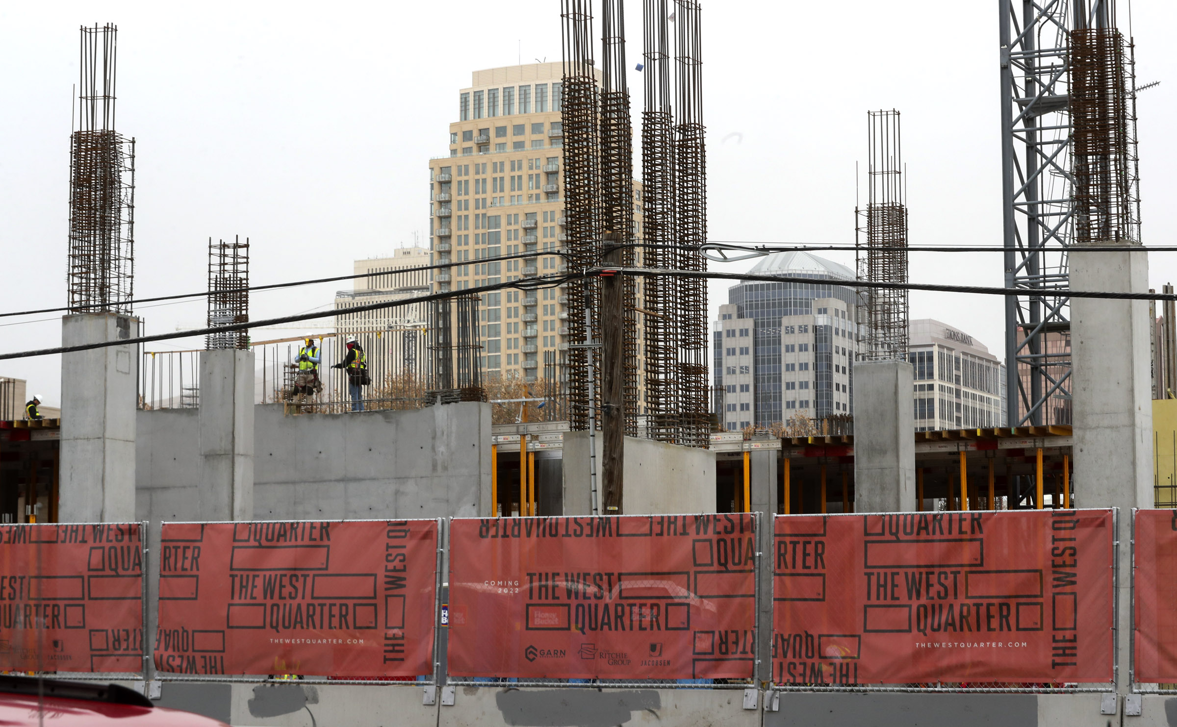 The Salt Lake City skyline rises above construction on the West Quarter, a multiuse development that will feature resident living, retail space and a hotel on Wednesday, Nov. 18, 2020. The development is located at 100 South and 300 West.