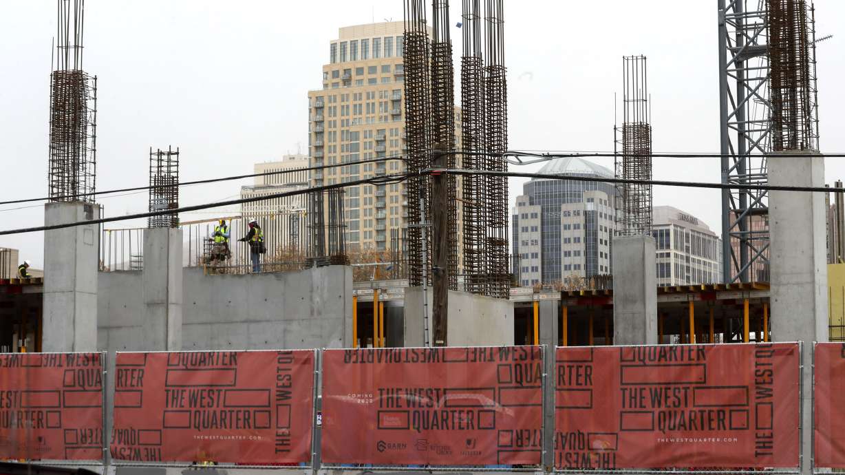 The Salt Lake City skyline rises above construction on the West Quarter, a multiuse development that will feature resident living, retail space and a hotel on Wednesday, Nov. 18, 2020. The development is located at 100 South and 300 West.