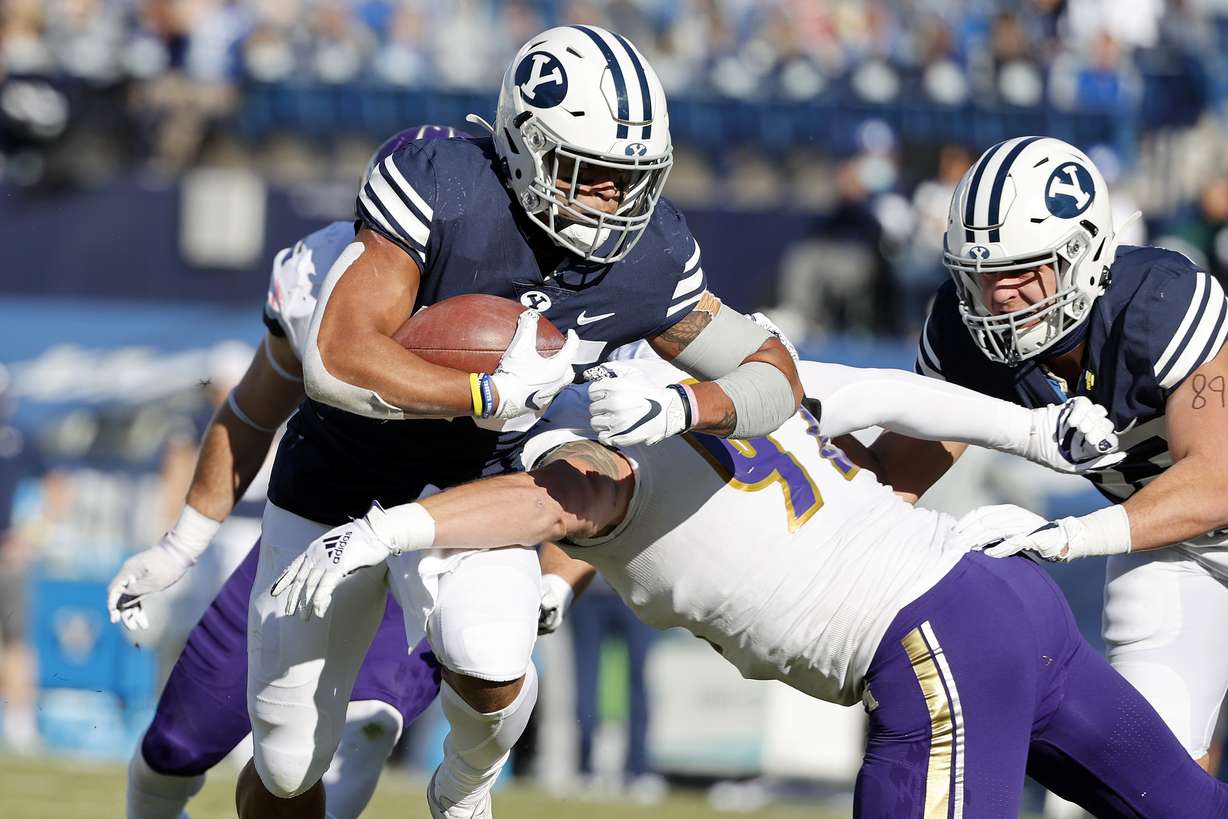 BYU running back Tyler Allgeier (25) runs the ball for a touchdown in the first quarter against North Alabama defensive lineman Charlie Ryan (92) during an NCAA college football game Saturday, Nov. 21, 2020, in Provo, Utah.