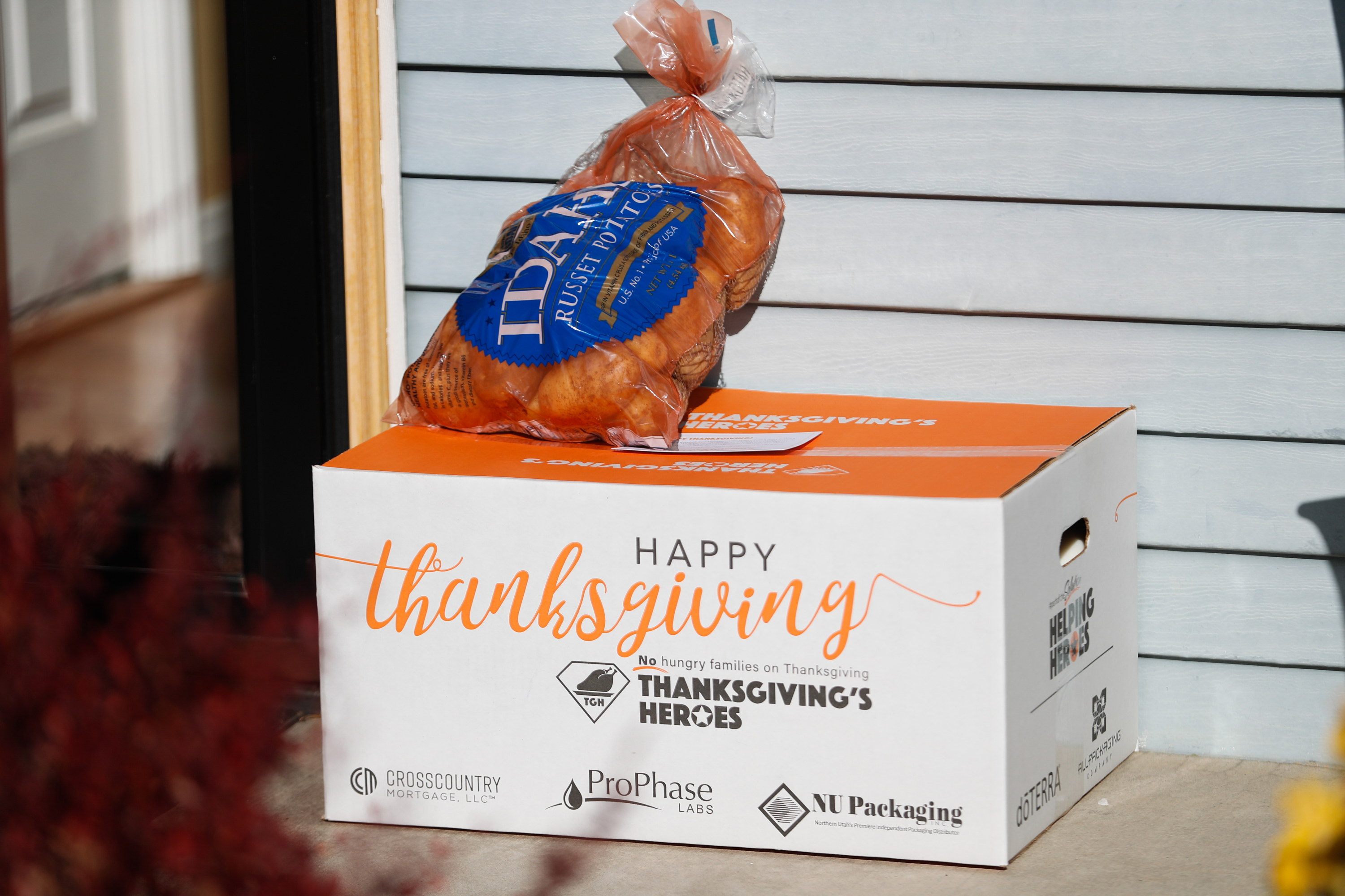 A box of food and a bag of potatoes from Thanksgiving's Heroes are pictured at the door of a recipient in Draper on Saturday, Nov. 21, 2020.