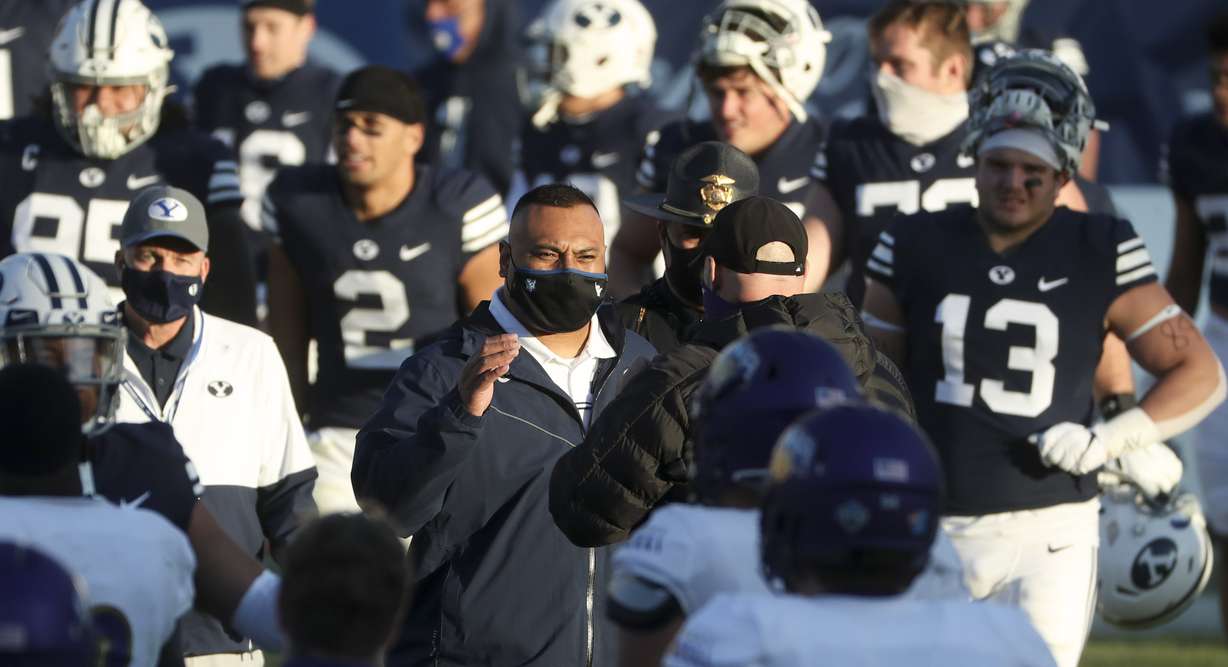 BYU head football coach Kalani Sitake, center, walks onto the field with his team after the Cougars defeated North Alabama in Provo on Saturday, Nov. 21, 2020.