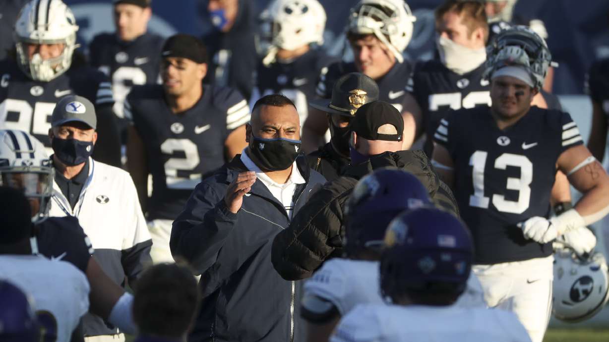 BYU head football coach Kalani Sitake, center, walks onto the field with his team after the Cougars defeated North Alabama in Provo on Saturday, Nov. 21, 2020.