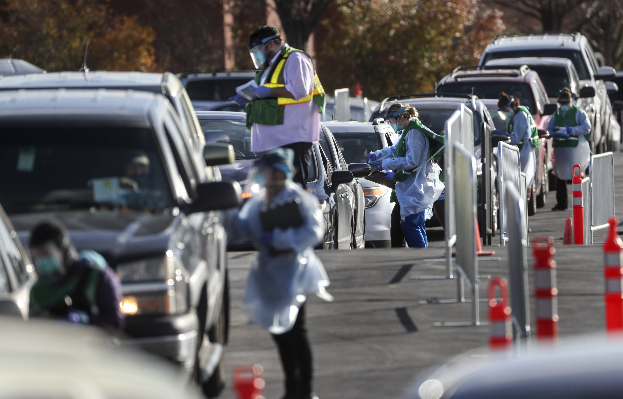 Salt Lake County mobile testers gather information from people as they wait in long lines to get tested for COVID-19 at the countyâ??s testing site in the Maverik Center parking lot in West Valley City on Tuesday, Nov. 17, 2020.