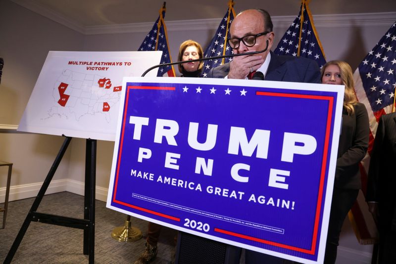 FILE PHOTO: Former New York City Mayor Rudy Giuliani, personal attorney to U.S. President Donald Trump, speaks as he holds a news conference about the 2020 U.S. presidential election results with fellow Trump attorneys Sidney Powell and Jenna Ellis at Republican National Committee headquarters in Washington, U.S., November 19, 2020. REUTERS/Jonathan Ernst