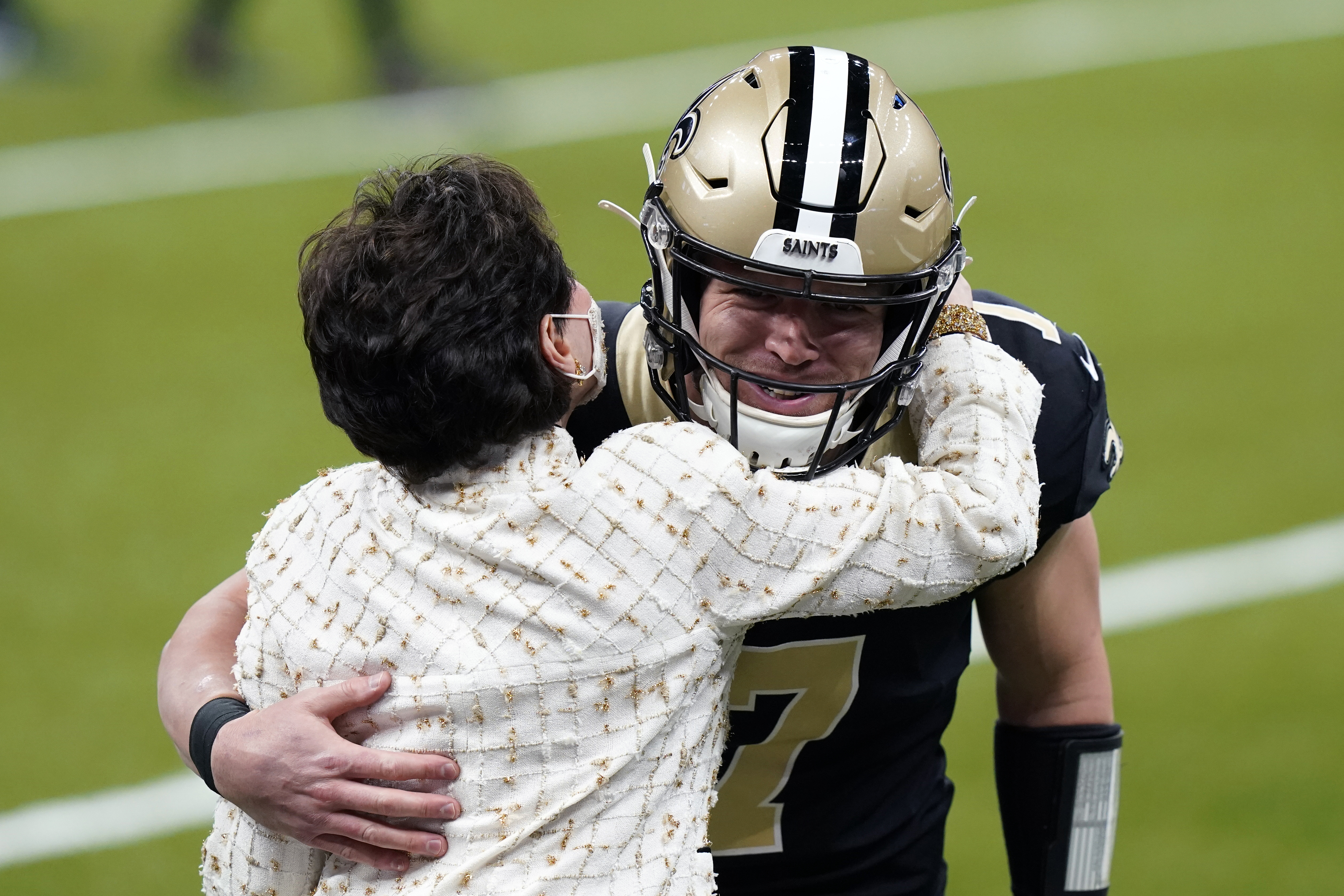 New Orleans Saints quarterback Taysom Hill (7), starting in place of an injured Drew Brees, hugs team owner Gayle Benson before an NFL football game against the Atlanta Falcons in New Orleans, Sunday, Nov. 22, 2020.