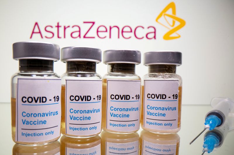 FILE PHOTO: Vials with a sticker reading, "COVID-19 / Coronavirus vaccine / Injection only" and a medical syringe are seen in front of a displayed AstraZeneca logo in this illustration taken October 31, 2020. REUTERS/Dado Ruvic