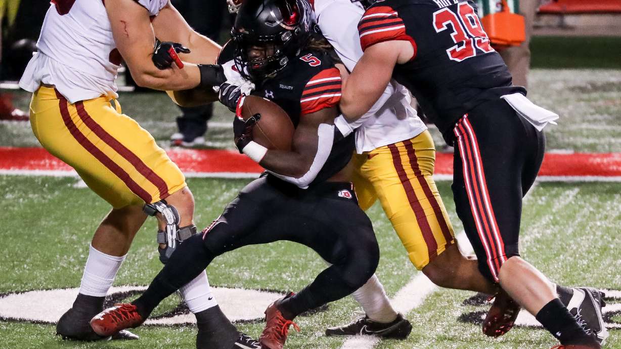 Utah Utes running back Jordan Wilmore (5) is tackled for a loss of yardage during the game against the USC Trojans at Rice-Eccles Stadium in Salt Lake City on Saturday, Nov. 21, 2020.