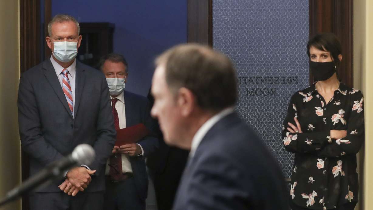 Rich Saunders, interim executive director of the Utah Department of Health, left, Taylor Randall, economic lead on Utah's Unified Command COVID-19 Response Team and dean of the David Eccles School of Business at the University of Utah, and Utah epidemiologist Dr. Angela Dunn, right, listen to Gov. Gary Herbert during a COVID-19 briefing at the Capitol in Salt Lake City on Monday, Nov. 23, 2020.