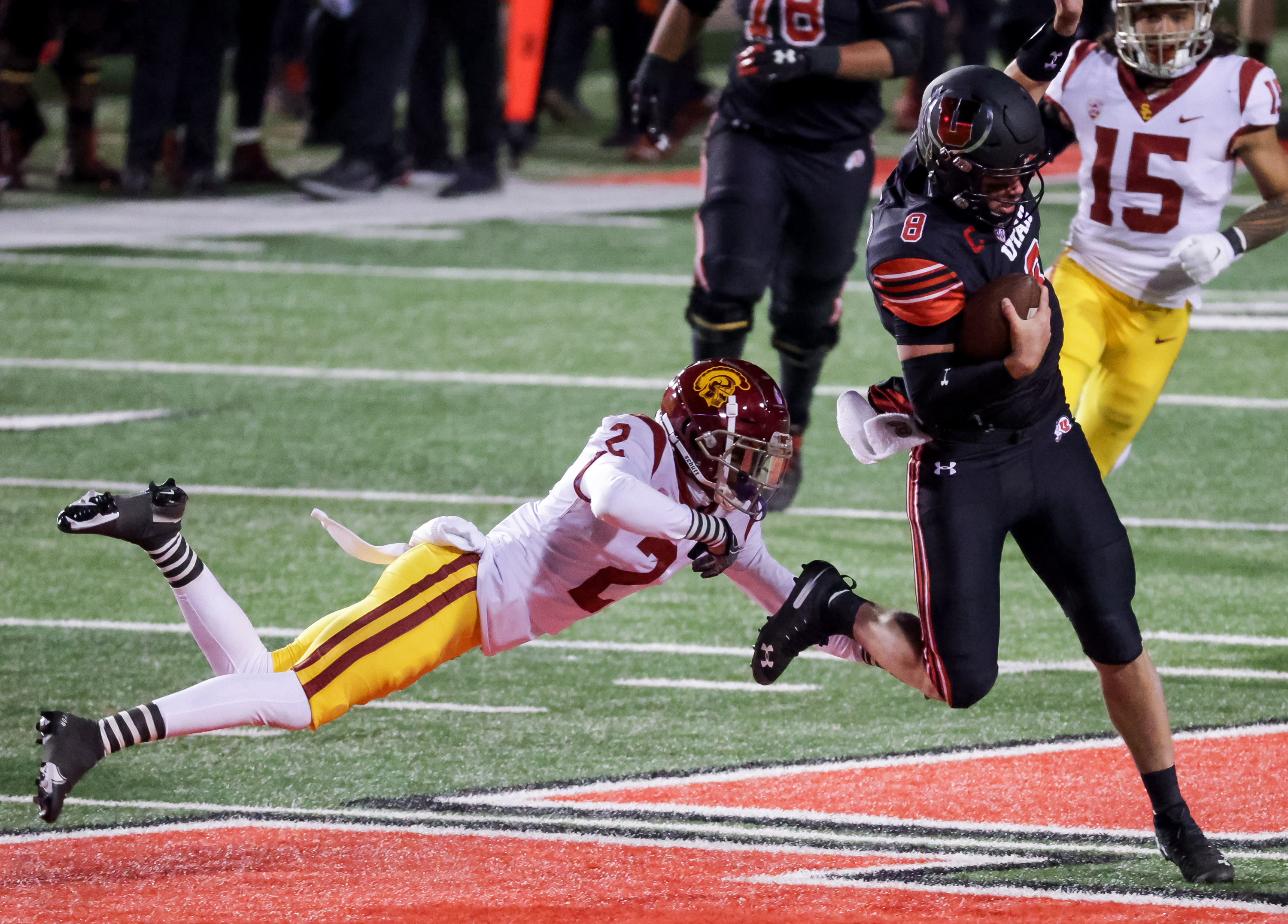 Utah Utes quarterback Jake Bentley (8) evades the tackle from USC Trojans cornerback Olaijah Griffin (2) at Rice-Eccles Stadium in Salt Lake City on Saturday, Nov. 21, 2020.
