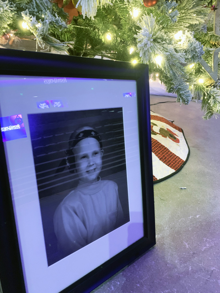 A framed photo of the late Nicole Meier, a cancer patient at Primary Children's Hospital, sits beside her mother's 29th decorated tree at The Festival of Trees on Monday, Nov. 23, 2020.