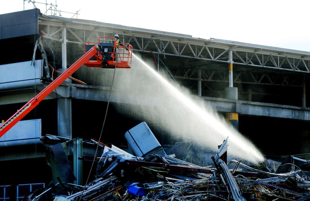 Water is sprayed to mitigate dust as workers dismantle the old parking garage and terminals at the Salt Lake City International Airport on Tuesday, Nov. 24, 2020.