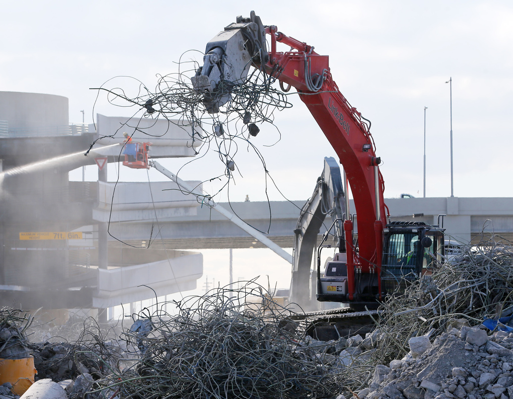 Workers dismantle the old parking garage and terminals at the Salt Lake City International Airport on Tuesday, Nov. 24, 2020.