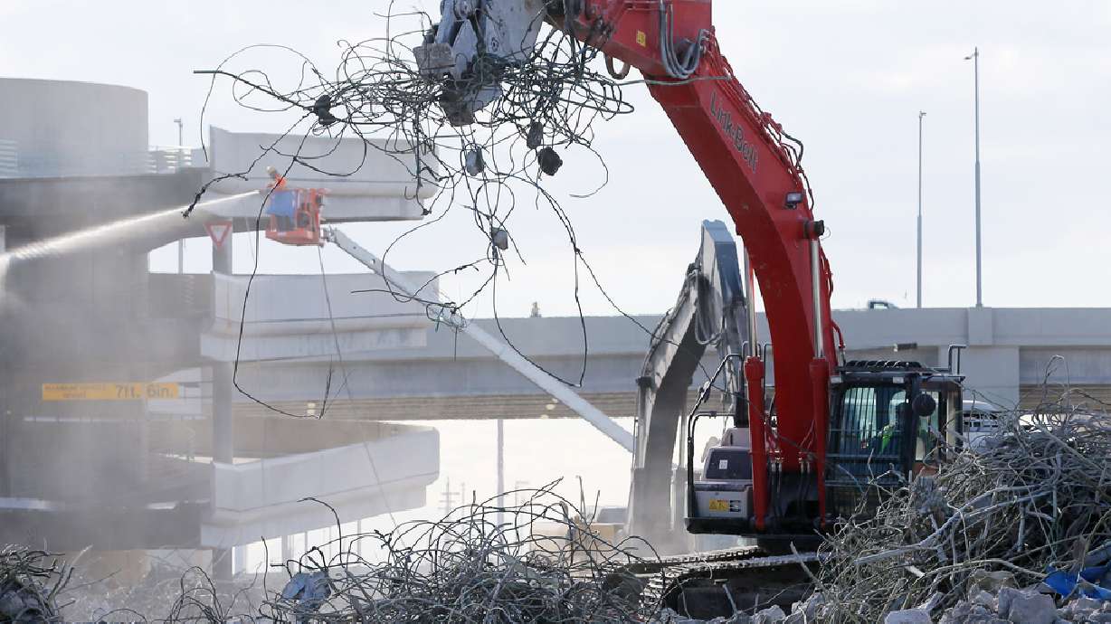 Workers dismantle the old parking garage and terminals at the Salt Lake City International Airport on Tuesday, Nov. 24, 2020.