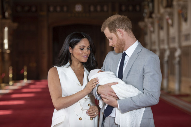 FILE - In this Wednesday May 8, 2019 file photo Britain's Prince Harry and Meghan, Duchess of Sussex, pose during a photocall with their newborn son Archie, in St George's Hall at Windsor Castle, Windsor, south England. The Duchess of Sussex has revealed that she had a miscarriage in July. Meghan described the experience in an opinion piece in the New York Times on Wednesday. She wrote: "I knew, as I clutched my firstborn child, that I was losing my second." The former Meghan Markle and husband Prince Harry have a son, Archie, born in 2019.