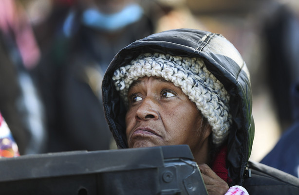 A woman wishing not to be identified shows her sadness after the Rescue Mission of Salt Lake ran out of boxed meals during its Two-Days-Before-Thanksgiving Banquet in Salt Lake City on Tuesday, Nov. 24, 2020.