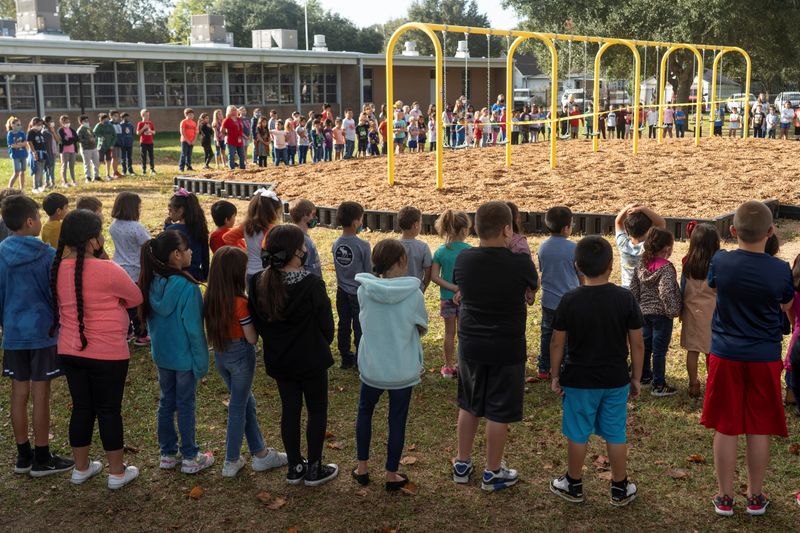 FILE PHOTO: Students at Louise Elementary School gather in the playground for a ceremony to reopen the swings, during the coronavirus disease (COVID-19) pandemic in Louise, Texas, U.S., November 20, 2020.  REUTERS/Go Nakamura