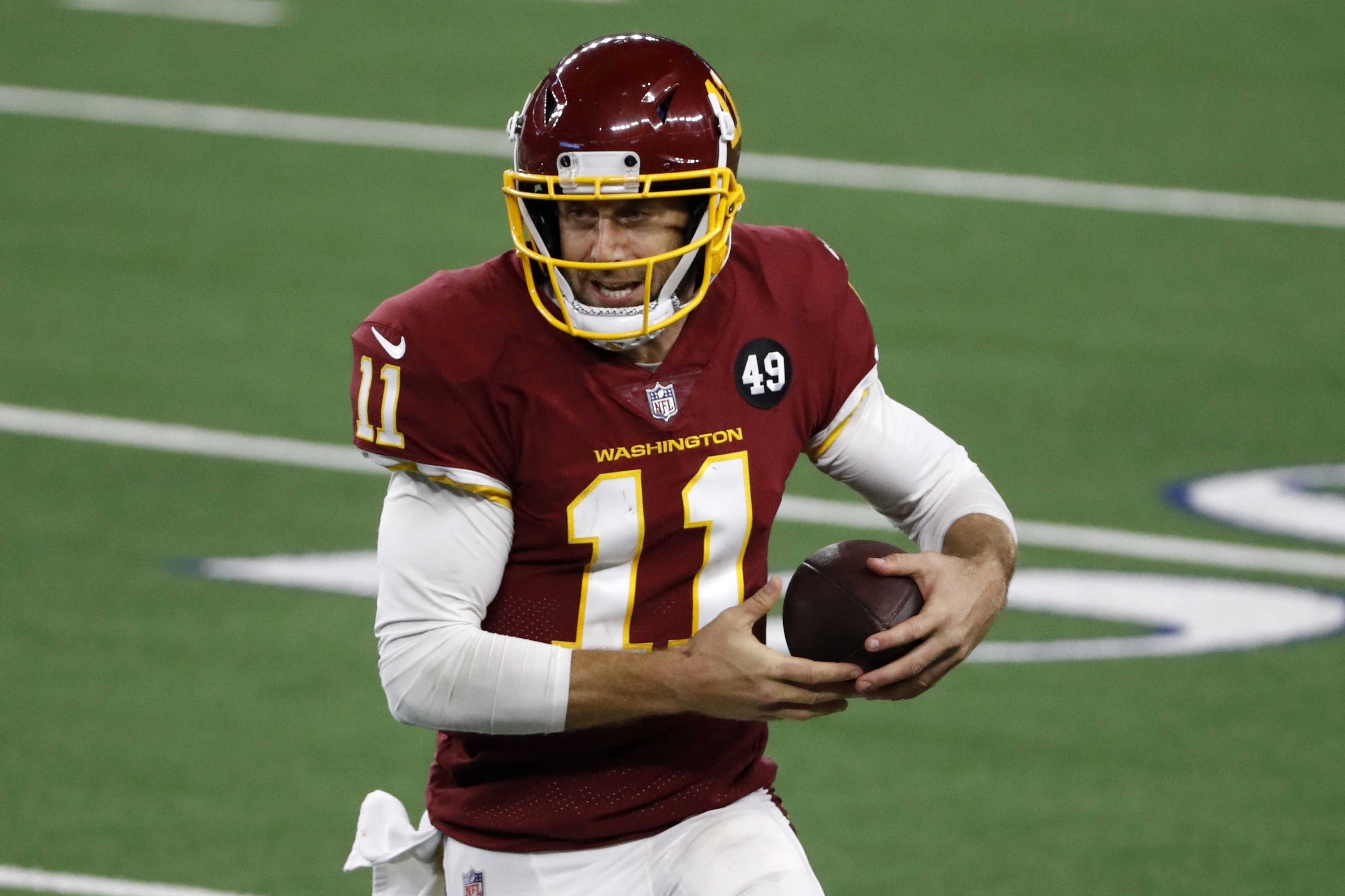 Washington Football Team quarterback Alex Smith (11) runs the ball in the second half of an NFL football game against the Dallas Cowboys in Arlington, Texas, Thursday, Nov. 26, 2020.