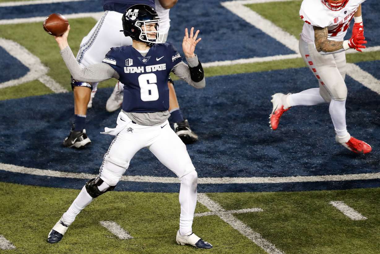 Utah State Aggies quarterback Andrew Peasley (6) sets to pass against the New Mexico Lobos defense during an NCAA football game at Maverik Stadium in Logan on Thursday, Nov. 26, 2020.