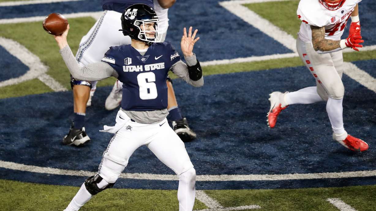 Utah State Aggies quarterback Andrew Peasley (6) sets to pass against the New Mexico Lobos defense during an NCAA football game at Maverik Stadium in Logan on Thursday, Nov. 26, 2020.