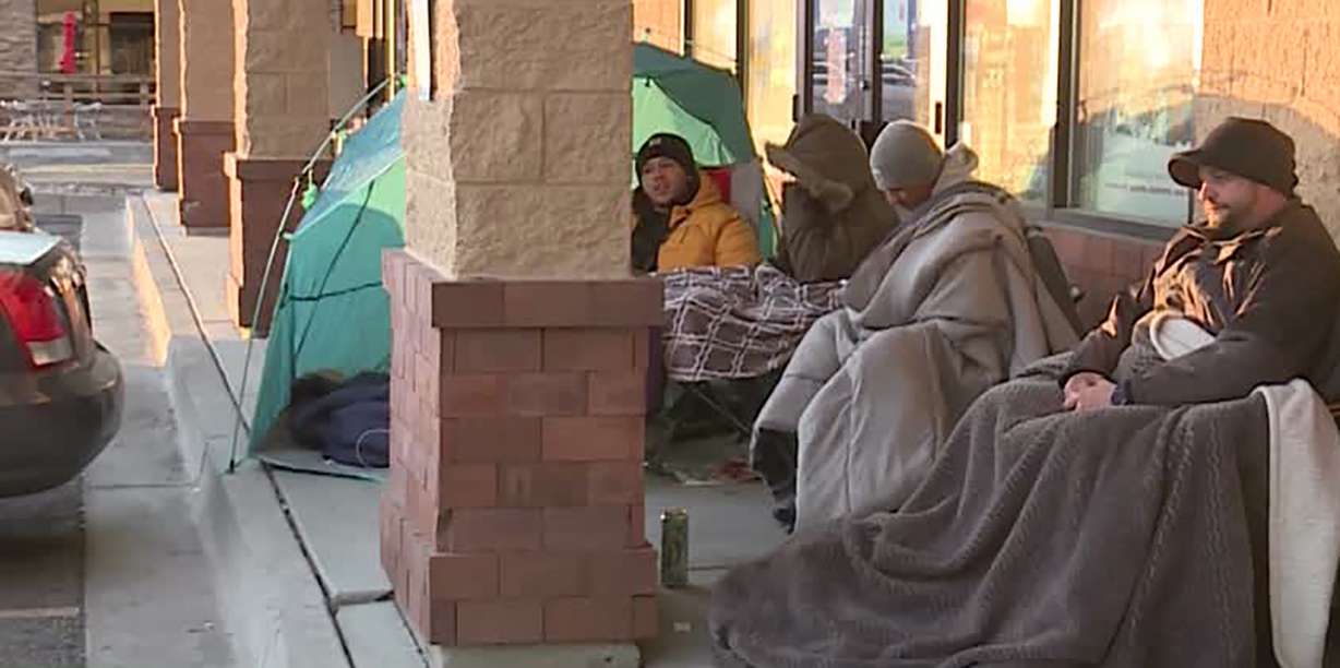 Shoppers brave the cold waiting outside a GameStop location in Sandy, Utah, Thursday, Nov. 26, 2020.