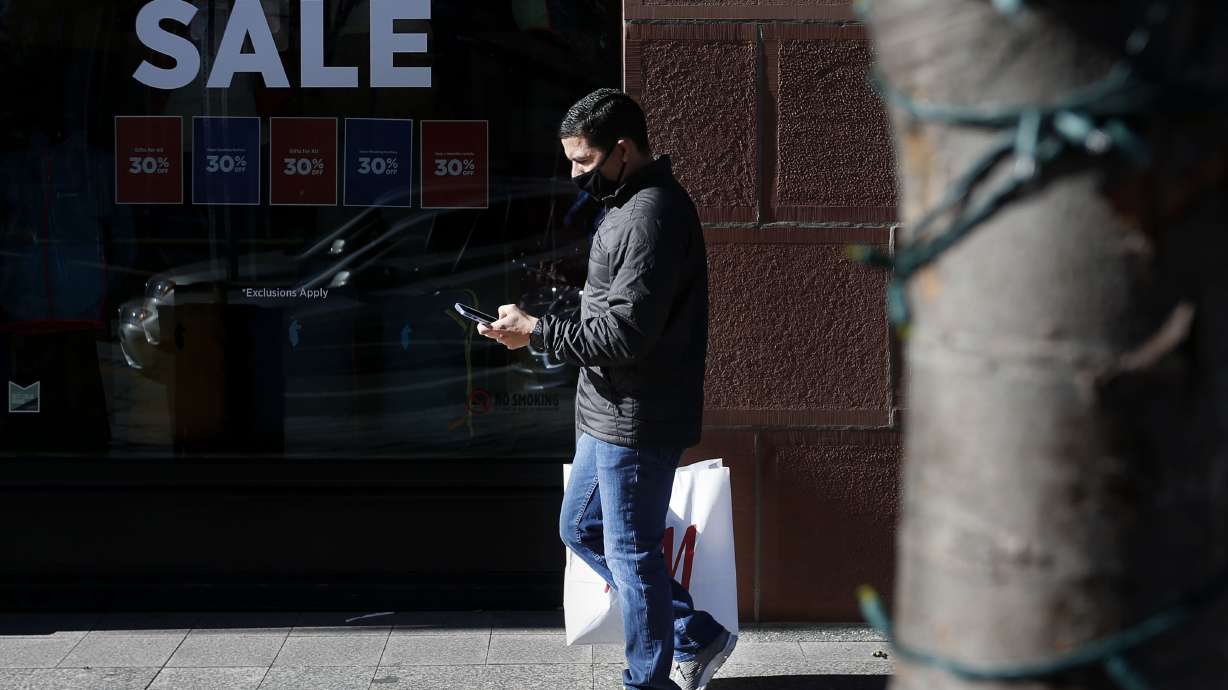 Roberto Gonzalez of Los Angeles walks down Main Street in Salt Lake City on an untraditionally quiet Black Friday, Nov. 27, 2020. Gonzalez said he enjoyed his shopping experience because he did not see people fighting over sale items as would be expected on a typical Black Friday.