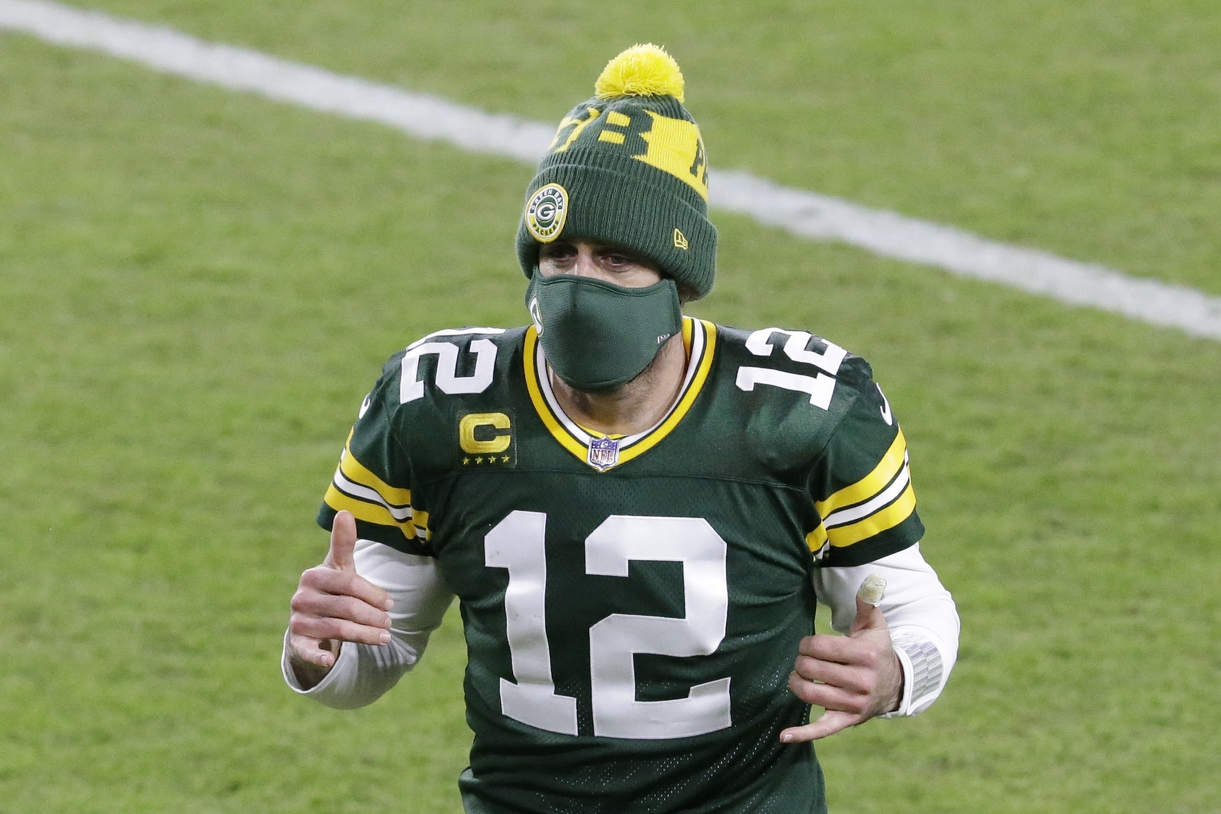 Green Bay Packers' Aaron Rodgers reacts as he runs off the field after an NFL football game against the Chicago Bears Sunday, Nov. 29, 2020, in Green Bay, Wis. The Packers won 41-25.