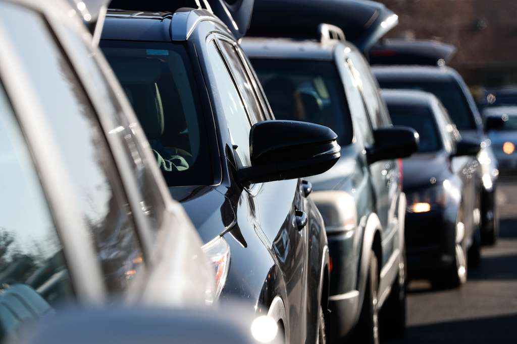 Recipients in cars wait in line to pick up food during a food bank distribution event in the parking lot of a Church of Jesus Christ meetinghouse in West Jordan on Monday, Nov. 30, 2020.