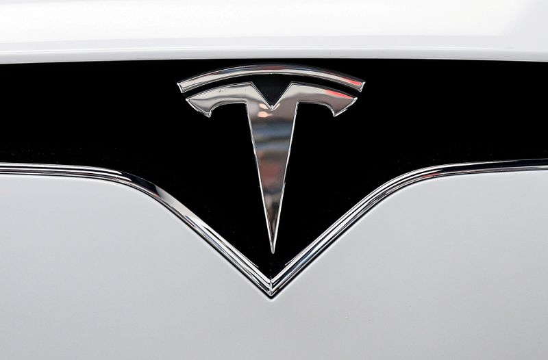 FILE PHOTO: The Tesla logo is seen on a car at Tesla's new showroom in Manhattan's Meatpacking District in New York City, U.S., Dec. 14, 2017. REUTERS/Brendan McDermid/File Photo