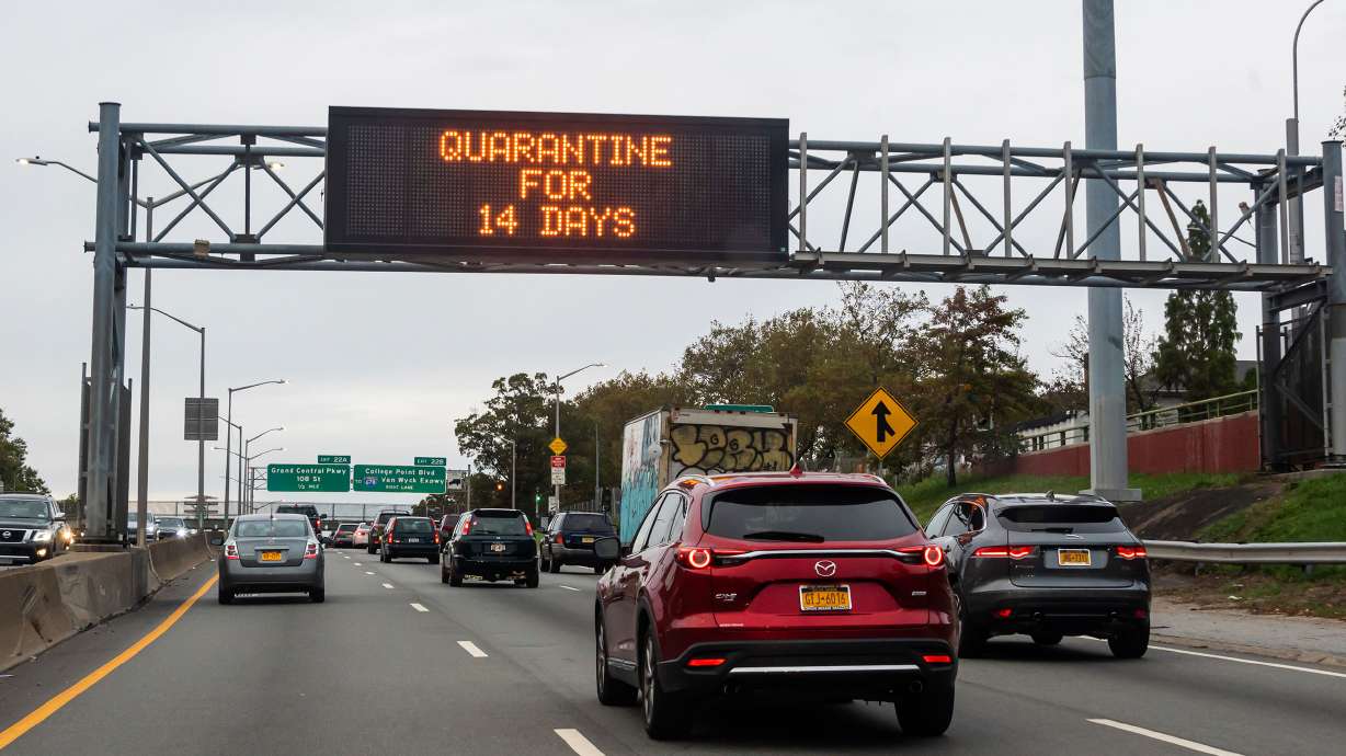 ONE TIME USE ONLY: CDC will decrease coronavirus quarantine time from 14 to 7-10 days. This image shows a traffic sign reading, "quarantine for 14 days" above a road in Brooklyn on October 25, 2020 in New York City.
