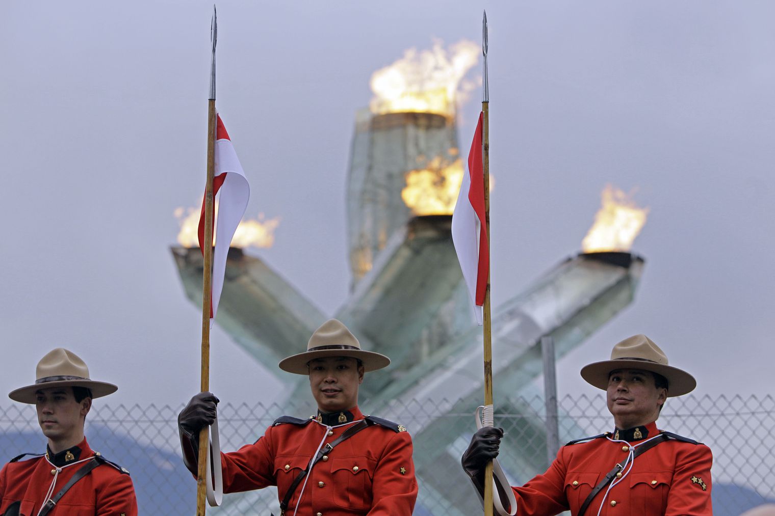 Members of the Royal Canadian Mounted Police are seen in front of the Olympic cauldron during a musical ride at the Vancouver 2010 Olympics in Vancouver, British Columbia on Tuesday, Feb. 23, 2010.