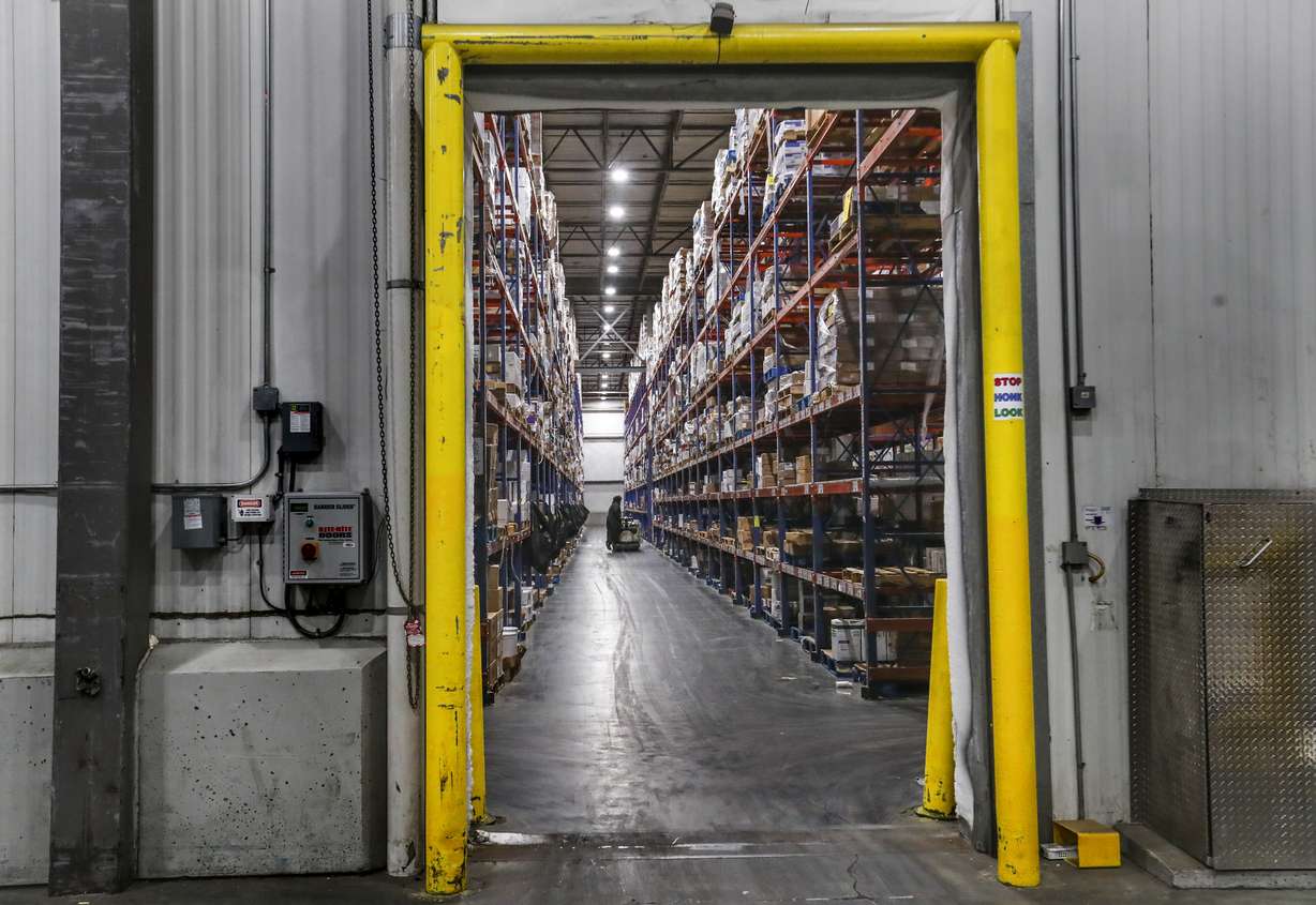 Food in cold storage is moved by loaders for Nicholas and Company into refrigerated trucks at the company’s warehouse in Salt Lake City on Tuesday, Dec. 1, 2020.