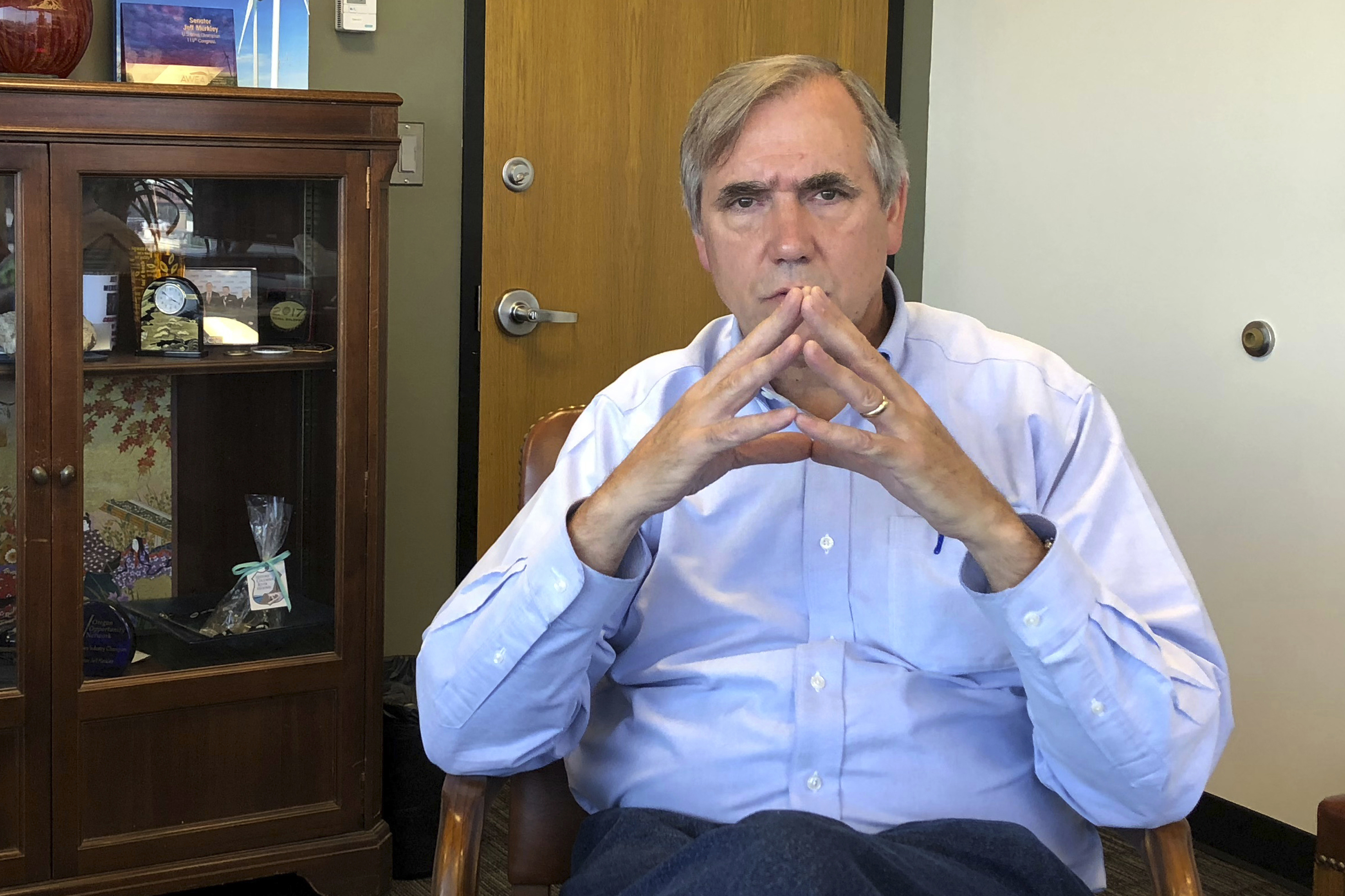 FILE - In this Sept. 7, 2018, file photo, Sen Jeff Merkley, D-Ore., sits for an interview in his office in Portland, Ore. National lawmakers, including Merkley, are expected on Wednesday, Dec. 2, 2020, to introduce a joint resolution aimed at striking language from the U.S. Constitution that enshrines a form of slavery in America’s foundational documents. (AP Photo/Andrew Selskey, File) [Dec-02-2020]