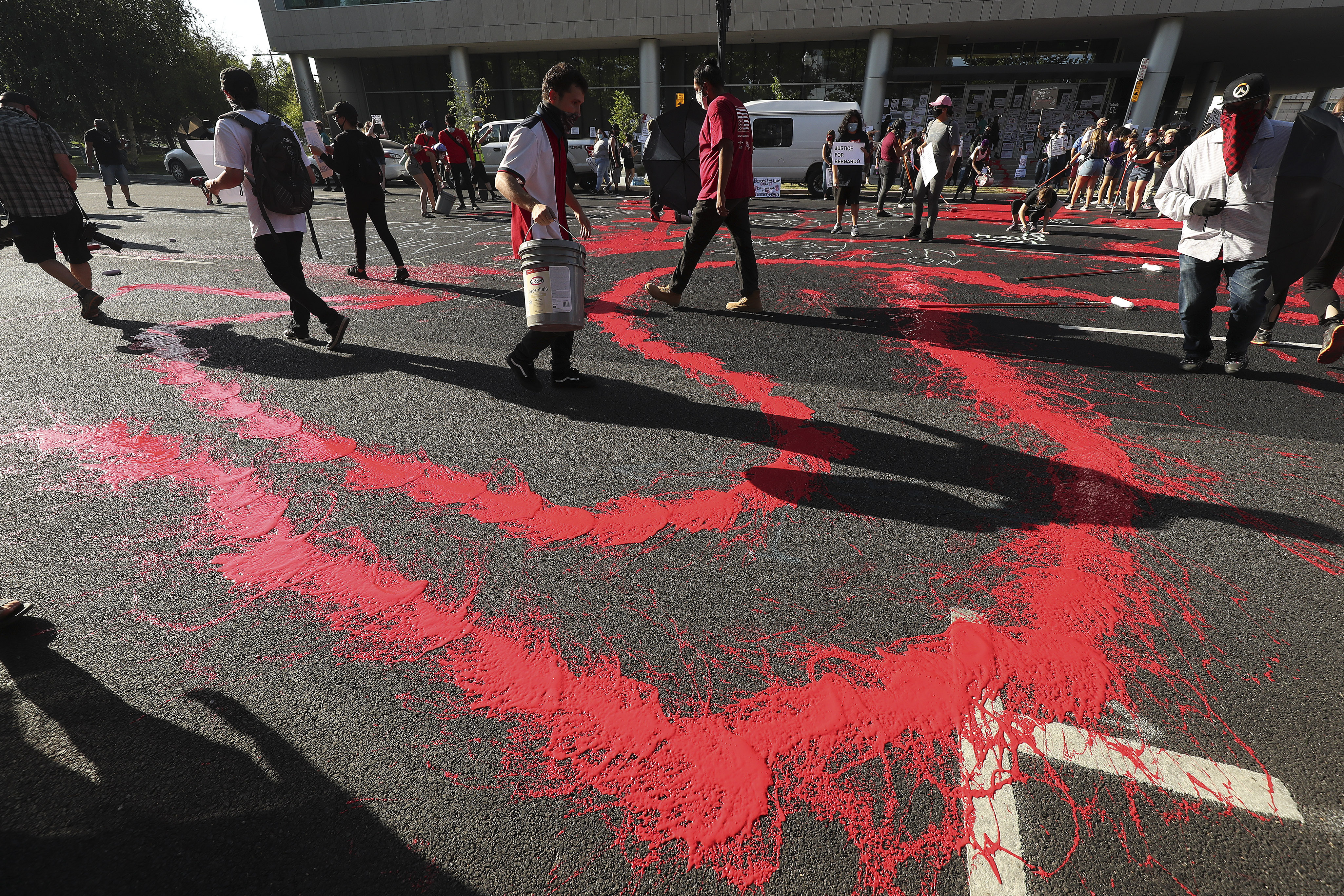 Protesters decrying the police shooting of Bernardo Palacios-Carbajal paint the street in front of the district attorney's office in Salt Lake City on Thursday, July 9, 2020.