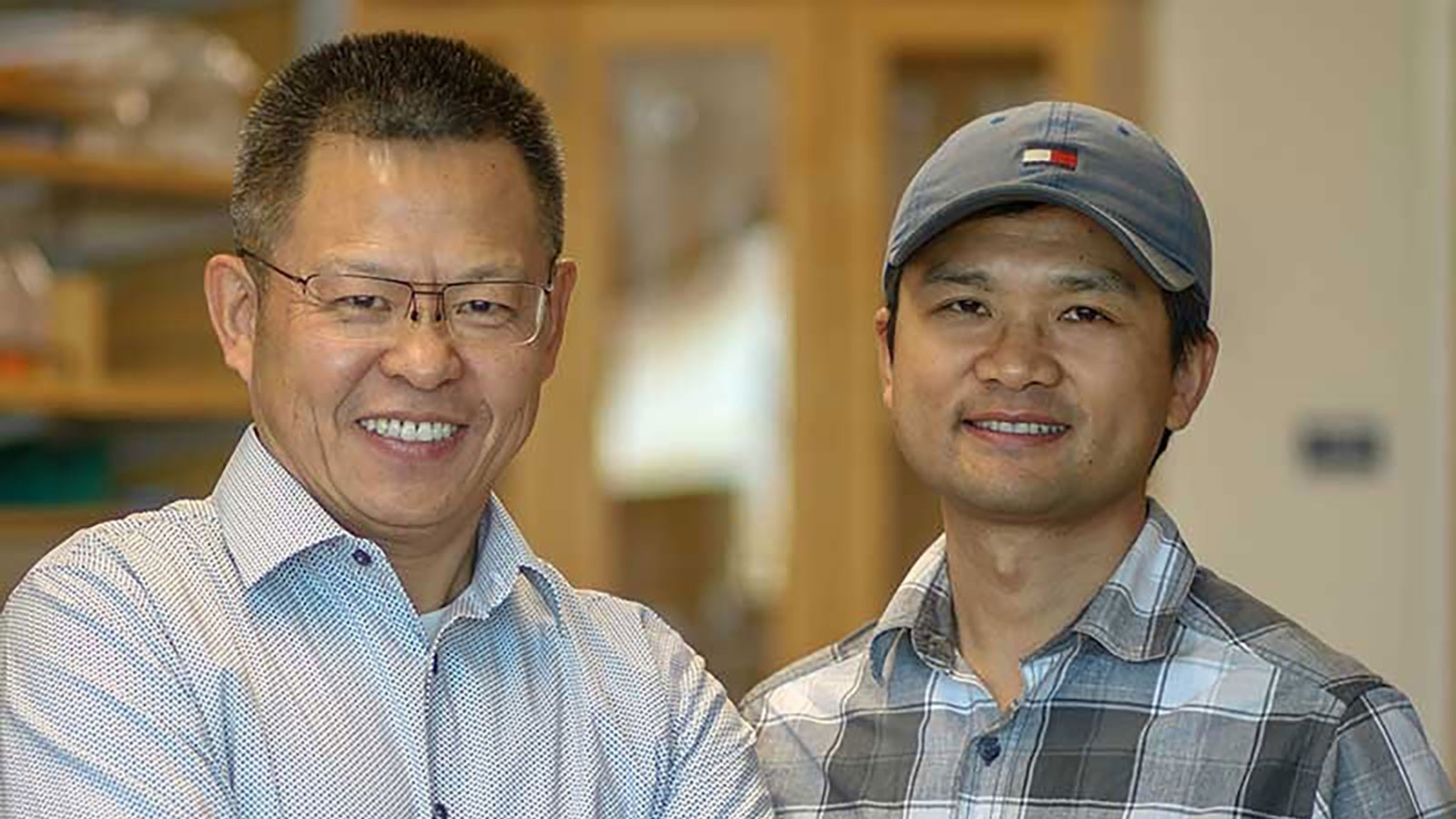 Animal science professor Zhongde Wang and postdoctoral fellow Rong Li pose for a photo in the Wang lab at Utah State University. Genetically engineered golden Syrian hamsters developed in Wang's lab are important in a newly published study of a potential COVID-19 vaccine.