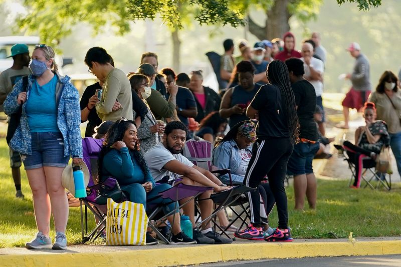 FILE PHOTO: Hundreds of people line up outside the Kentucky Career Center, over two hours prior to its opening, to find assistance with their unemployment claims, in Frankfort, Kentucky, U.S. June 18, 2020. REUTERS/Bryan Woolston