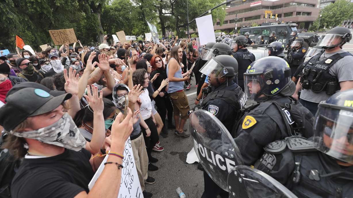 Protesters square off with police in Salt Lake City on Saturday, May 30, 2020. Protesters joined others across the nation to decry the death of George Floyd, a black man, who died while being taken into custody by police in Minneapolis earlier this week.