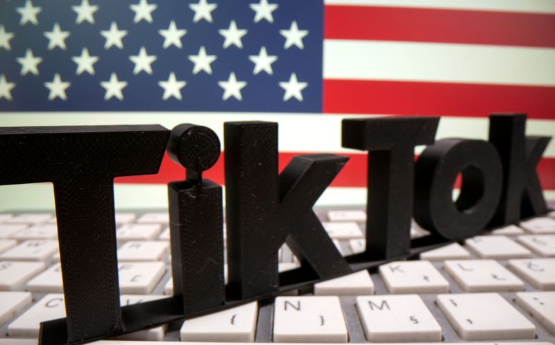FILE PHOTO: A 3D printed TikTok logo is placed on a keyboard in front of U.S. flag in this illustration taken October 6, 2020. Picture taken October 6, 2020. REUTERS/Dado Ruvic/Illustration