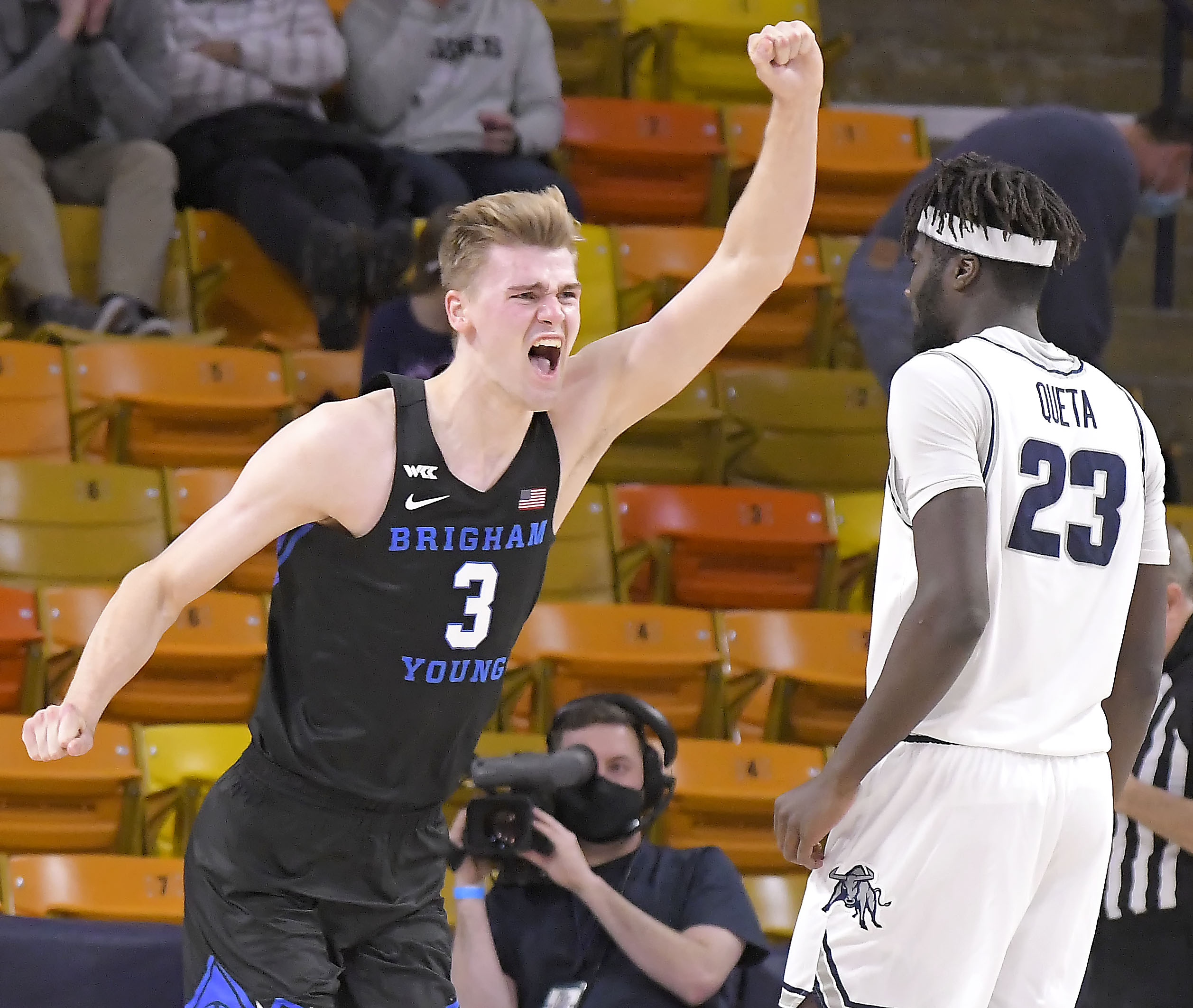 BYU forward Matt Haarms (3) celebrates next to Utah State center Neemias Queta (23) after the Cougars won an NCAA college basketball game 67-64 on Saturday, Dec. 5, 2020, in Logan, Utah. (Eli Lucero/The Herald Journal via AP, Pool)