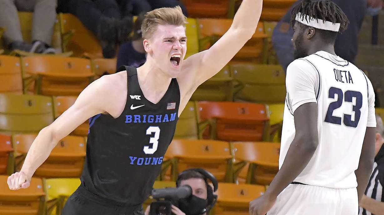 BYU forward Matt Haarms (3) celebrates next to Utah State center Neemias Queta (23) after the Cougars won an NCAA college basketball game 67-64 on Saturday, Dec. 5, 2020, in Logan, Utah. (Eli Lucero/The Herald Journal via AP, Pool)