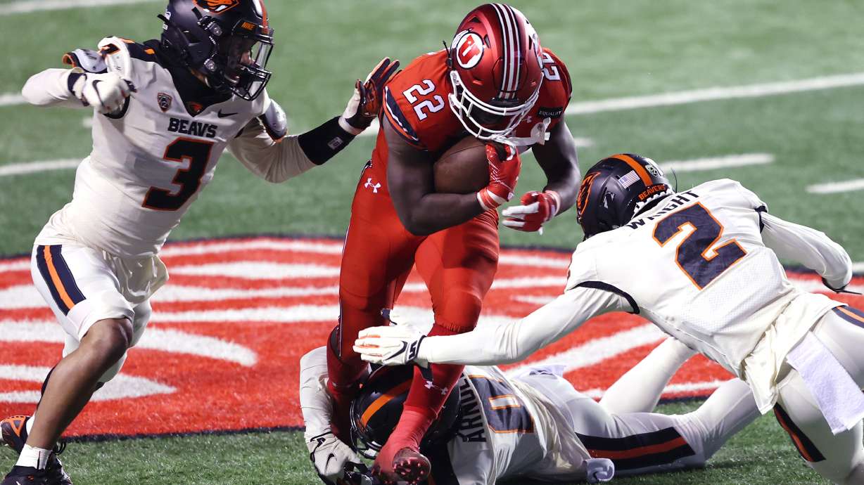 Utah Utes running back Ty Jordan (22) runs with the ball as Utah and Oregon State play a college football game at Rice-Eccles Stadium in Salt Lake City on Saturday, Dec. 5, 2020.