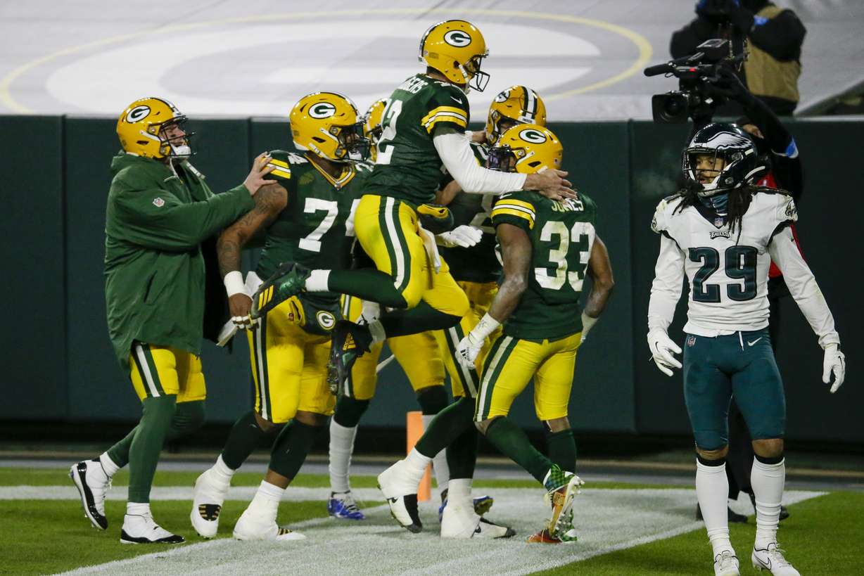 Green Bay Packers' Aaron Jones is congratulated by quarterback Aaron Rodgers (12) after running for a 77-yard touchdown during the second half of an NFL football game against the Philadelphia Eagles Sunday, Dec. 6, 2020, in Green Bay, Wis.