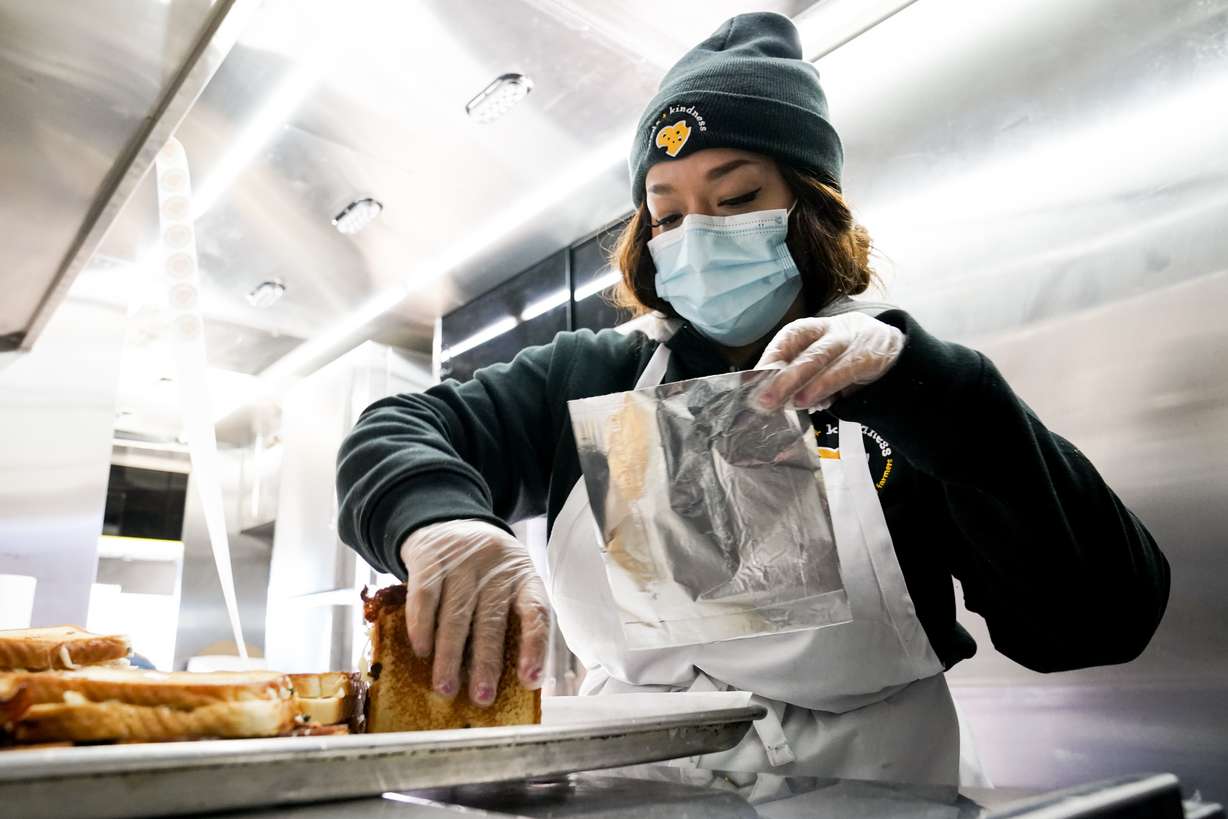 Lissette Torres with the Curds + Kindness campaign prepares to package a fresh grilled cheese sandwich to be distributed at the University of Utah Health Care facility in South Jordan on Monday, Nov. 30, 2020.